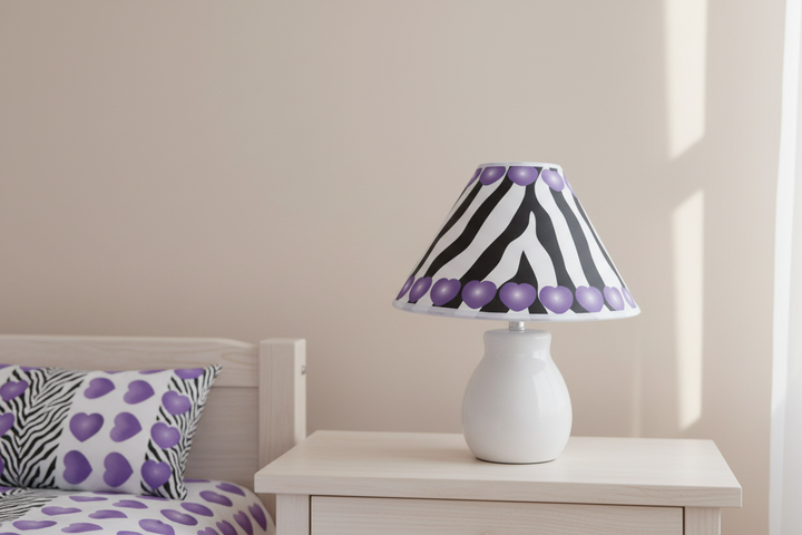 Purple Hearts Zebra Print Lamp Shade on nightstand against simple wall in purple zebra girls nursery